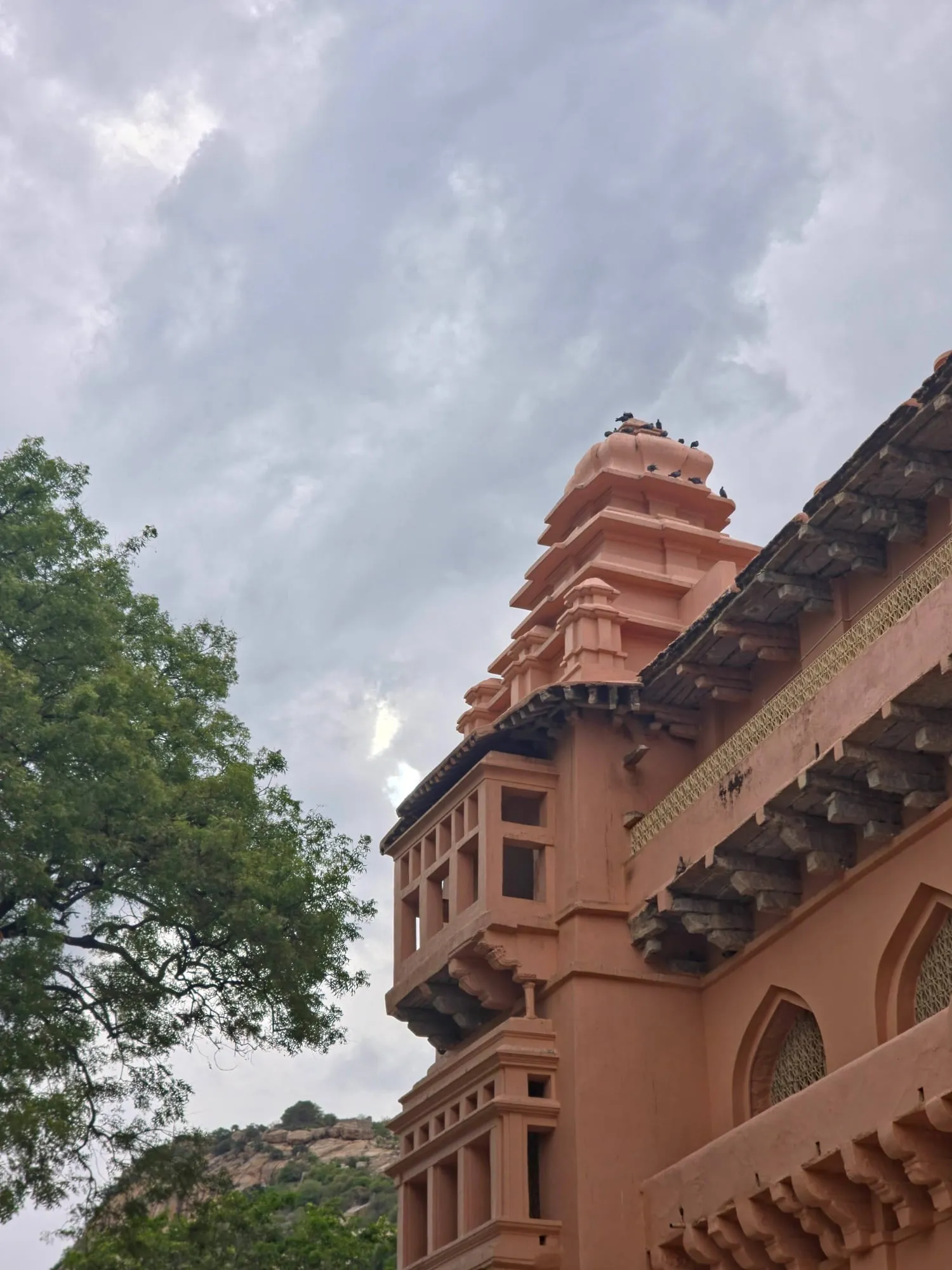 An ornate sandstone palace framed by trees