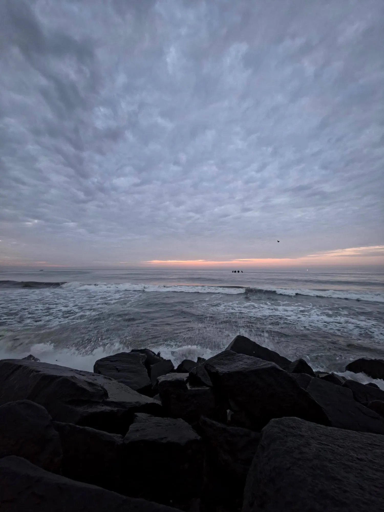 Waves breaking on rocks at dawn