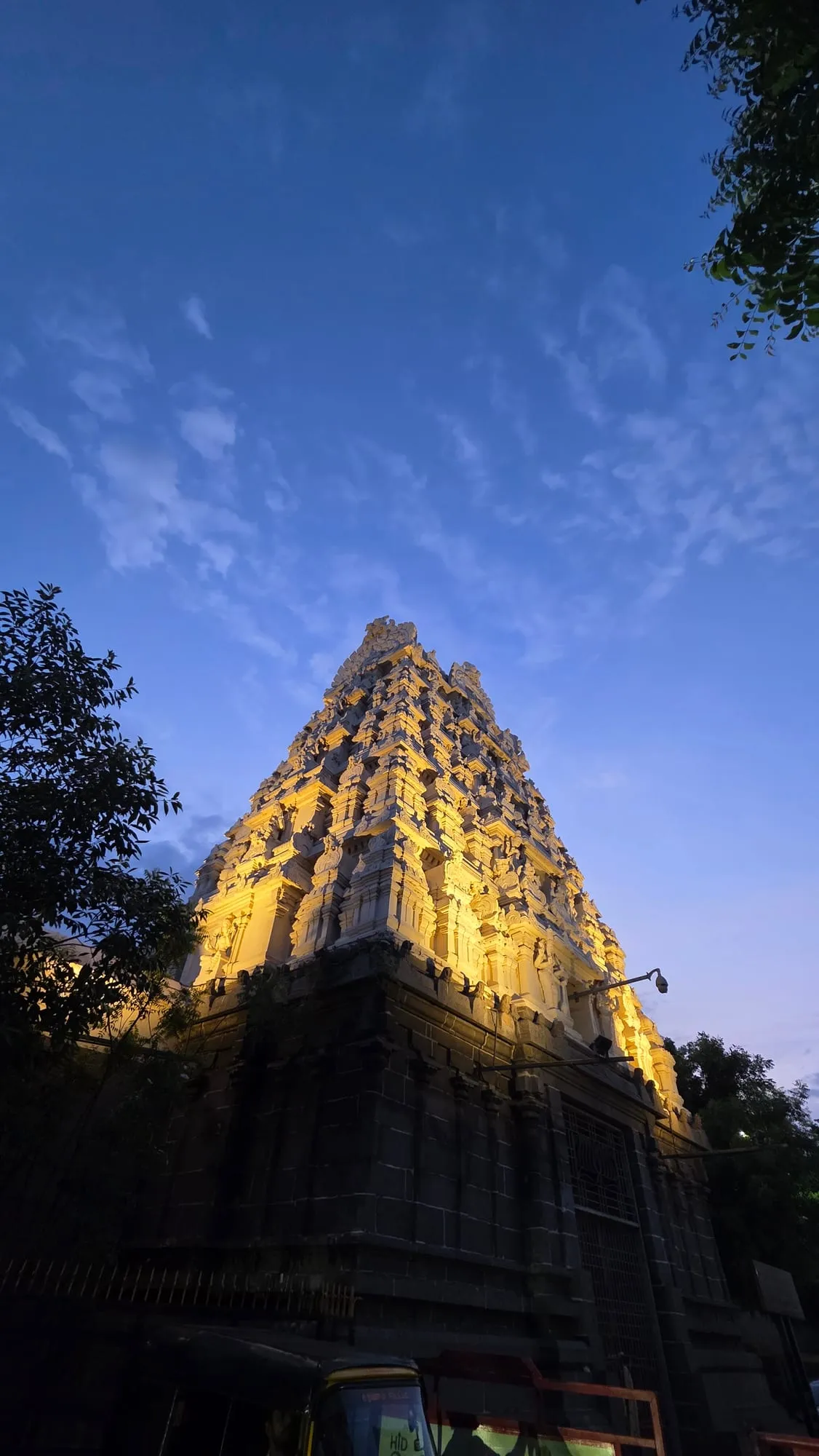 A temple tower lit up at dusk